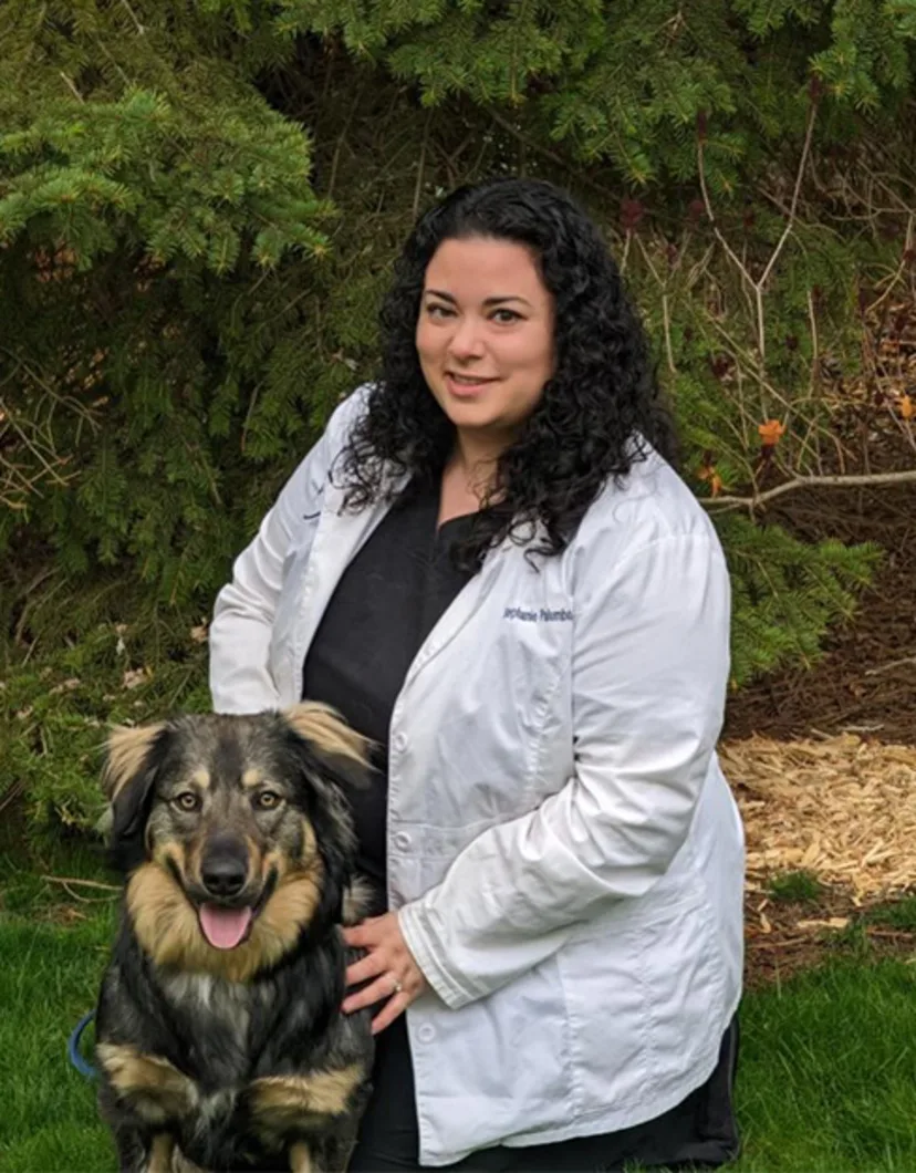 Dr. Stephanie Palumbo next to a dog outside